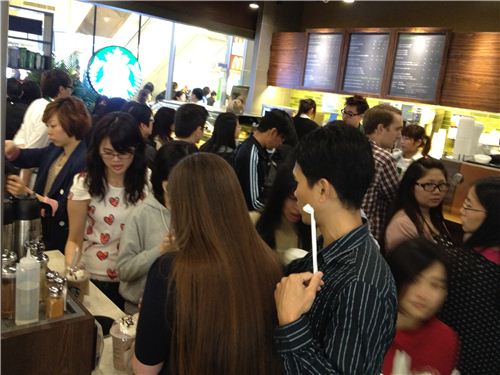 Out team pushed to one side of the new and highly packed Starbucks coffee shop