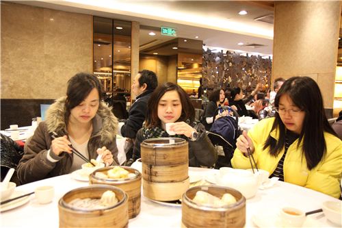 Karen, Lok and Sylvania are busy eating and drinking tea