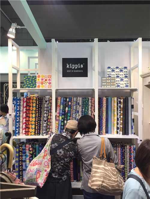 Curious attendees take a look at fabrics
