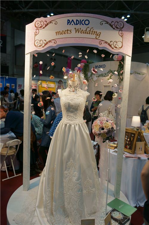 The wedding dress is not made from clay, but all the decoration around it