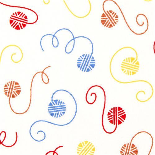 white fabric with colourful balls of wool by Robert Kaufman