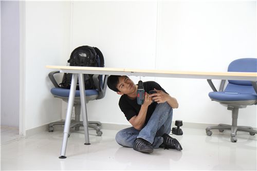 Alan is disassembling the furniture